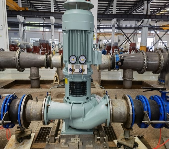 Industrial pump system with gauges and pipes in a factory setting.