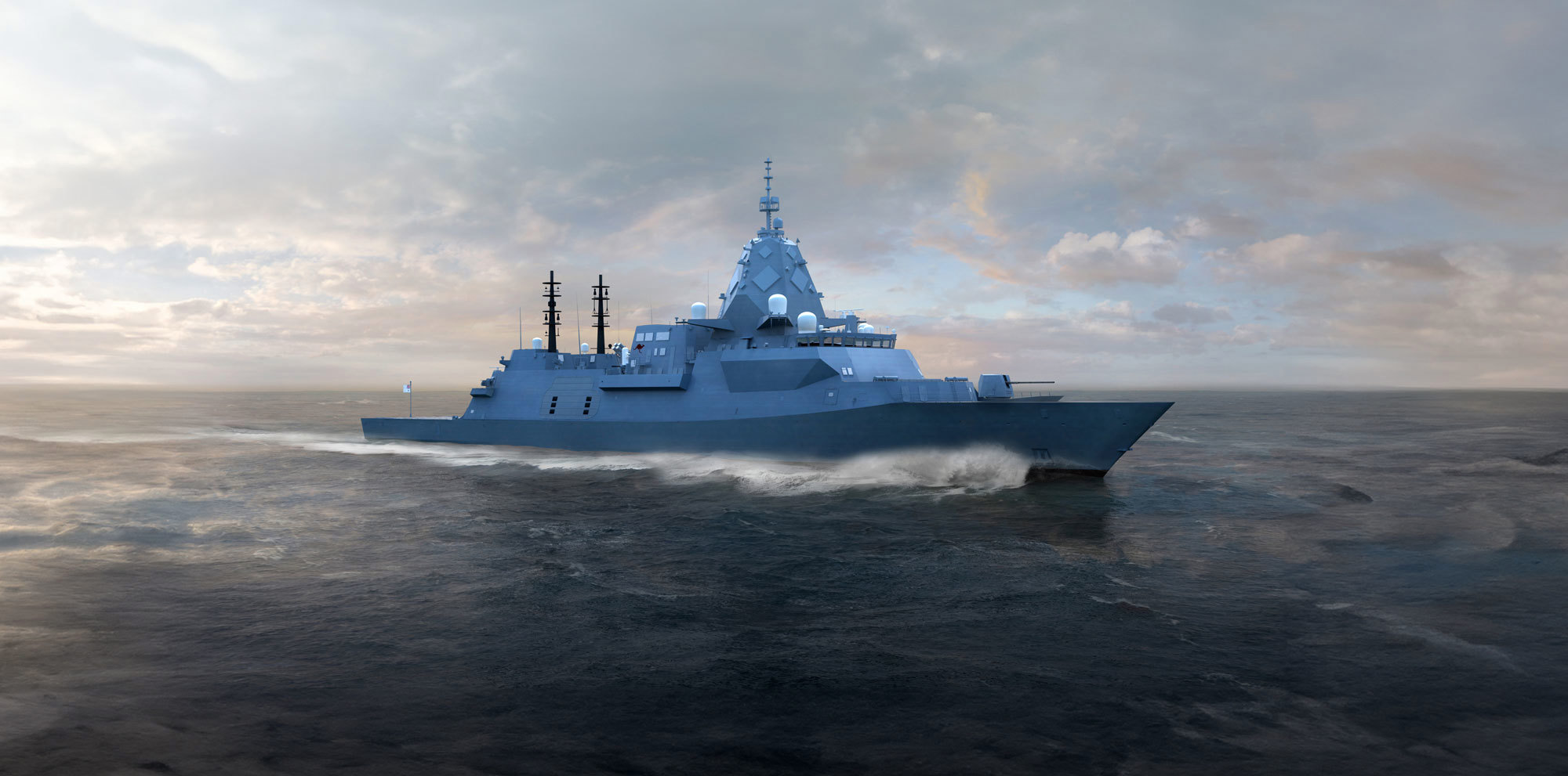 A modern warship cruising through the ocean under a cloudy sky.