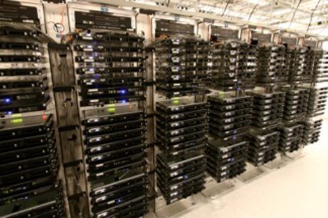 Rows of server racks in a data center with numerous black server units.