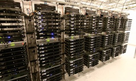 Rows of server racks in a data center with numerous black server units.