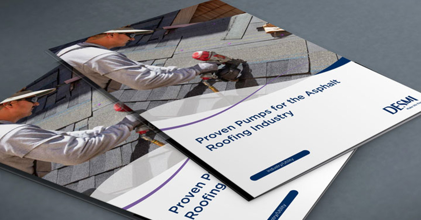 DESMI brochure featuring pumps for the asphalt roofing industry on a gray surface.