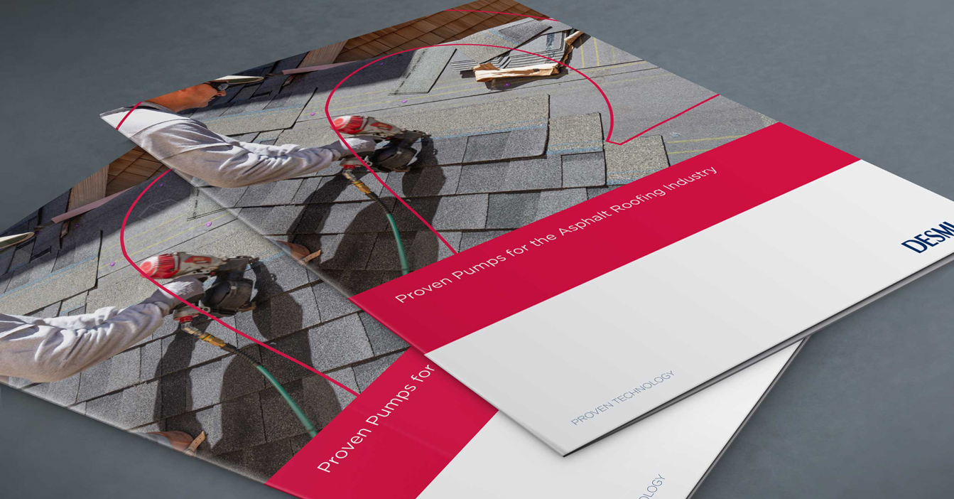 DESMI brochure featuring pumps for the asphalt roofing industry on a gray surface.