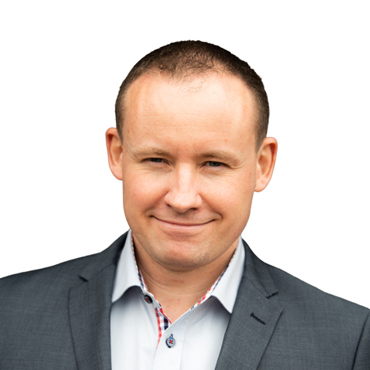 Man wearing a blue plaid shirt against a white background.