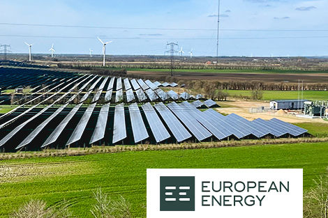 Solar farm with wind turbines in background, logo reads "European Energy."