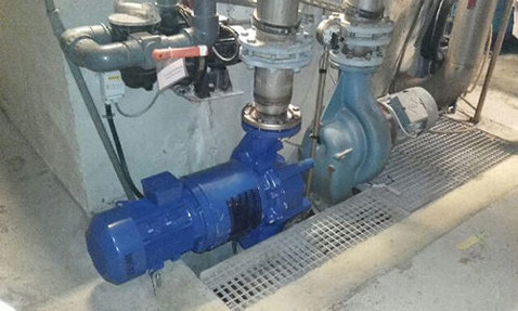 Industrial pump system installed with connected piping for fluid handling.