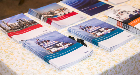 Brochures featuring DESMI marine and industrial solutions displayed on a table.