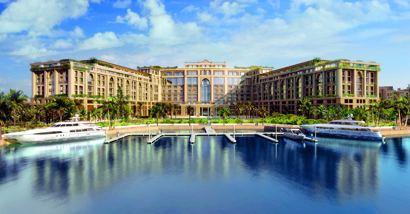 Luxurious waterfront hotel with yachts moored at the marina under a blue sky.