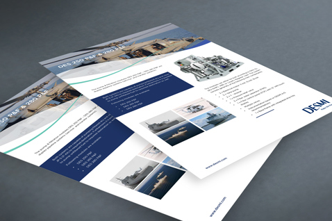 DESMI product brochures featuring marine and industrial equipment on a gray surface.