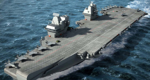 Aircraft carrier sailing on the ocean with fighter jets on deck.