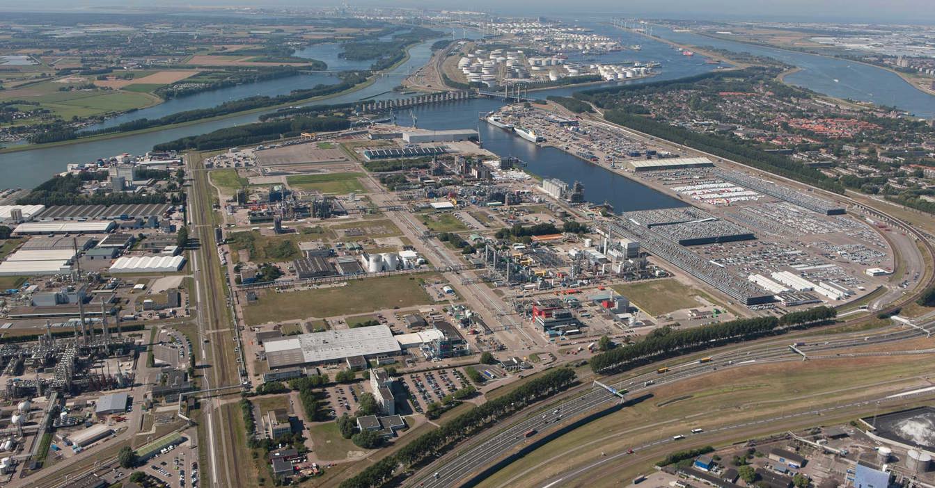Aerial view of an industrial area with waterways and surrounding landscape.
