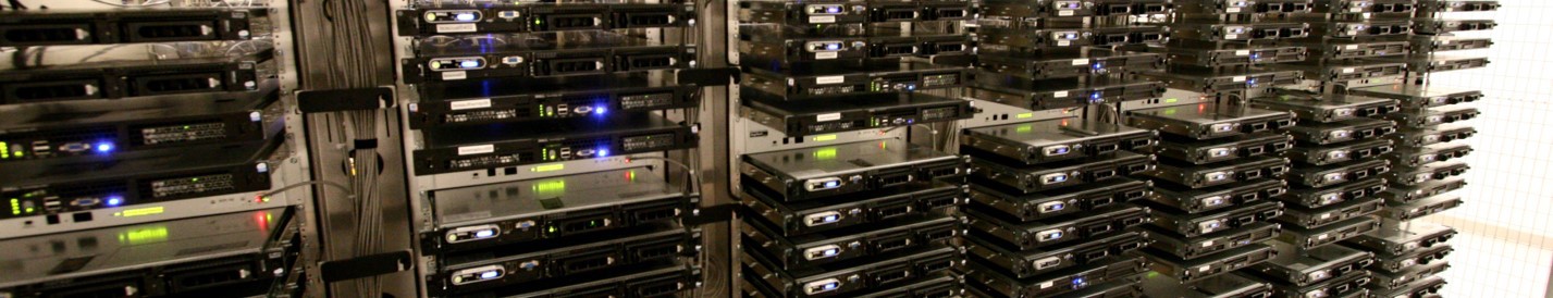 Rows of stacked servers with illuminated indicator lights in a data center.