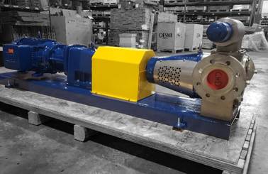 DESMI industrial pump on a pallet in a warehouse, used for fluid handling.