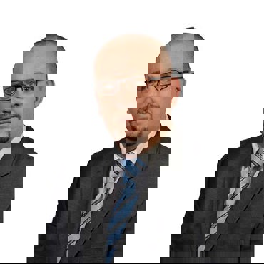 Man in suit and glasses with a light blue striped tie.