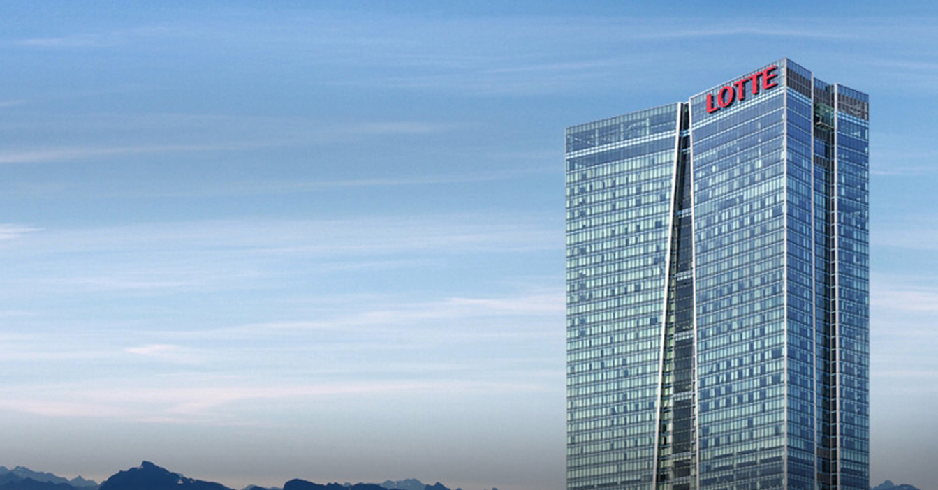 Tall glass skyscraper with "LOTTE" logo, set against a clear blue sky.
