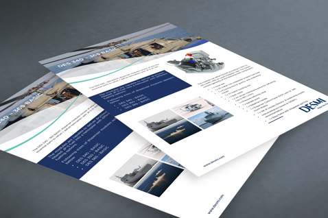 DESMI brochures featuring marine and industrial equipment details on a gray surface.