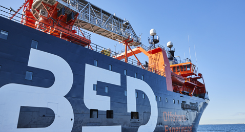 Offshore experience ship with large "BED" letters and equipment on deck.