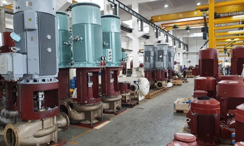 Industrial facility with large DESMI pumps for fluid handling, featuring various models.