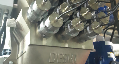 DESMI industrial equipment with multiple valves and cables for fluid handling applications.