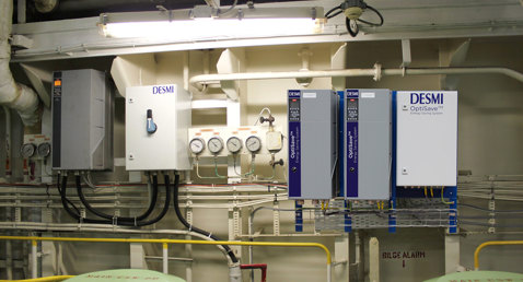 DESMI OptiSave energy-saving system with gauges and control panels for fluid handling.