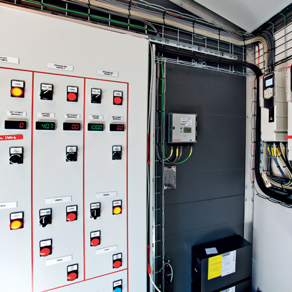 Control panel with gauges and switches for industrial fluid handling system.