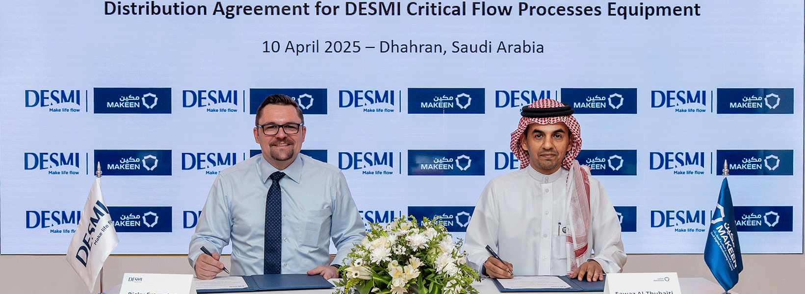 Two men signing DESMI distribution agreement in Dhahran, Saudi Arabia, April 2025.