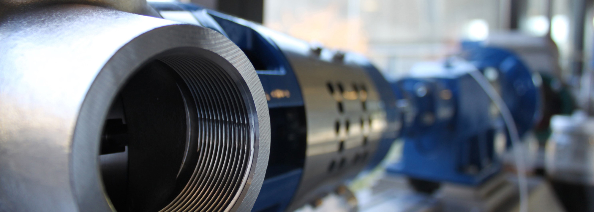 Close-up of a DESMI pump, highlighting its metal components and threaded opening.