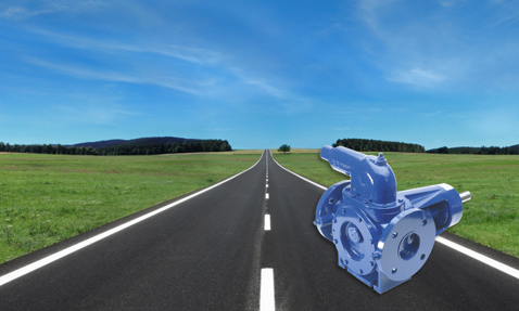 DESMI pump on an open road against a clear blue sky background.