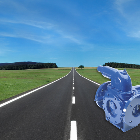 DESMI pump on an open road against a clear blue sky background.