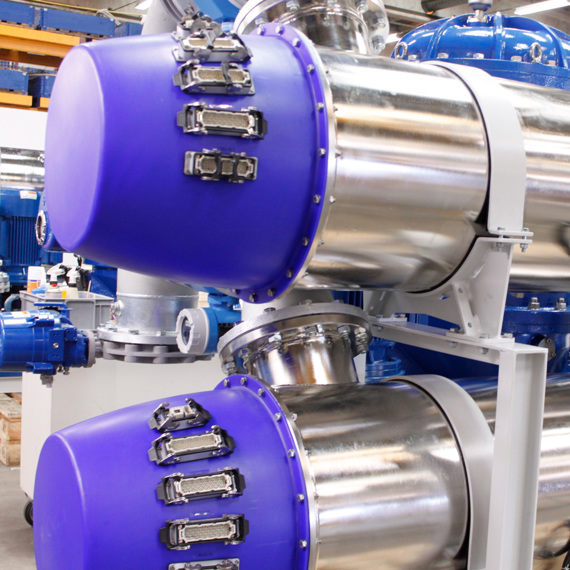 Industrial fluid handling equipment with metallic cylinders and blue end caps.