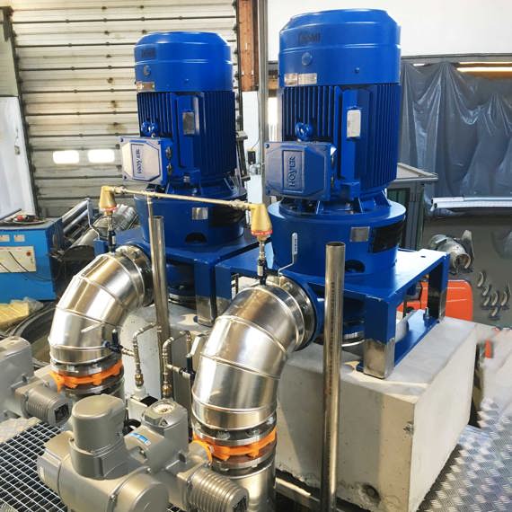 Blue DESMI pumps for industrial fluid handling, with metal piping connections.
