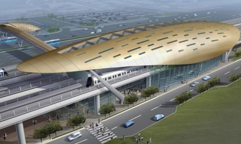 Futuristic train station with a sleek, gold roof and modern architectural design.