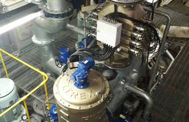 Industrial machinery with pipes and a large Filtrex unit for fluid handling.