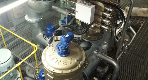 Industrial machinery with pipes and a large Filtrex unit for fluid handling.