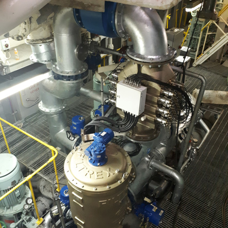 Industrial machinery with pipes and a large Filtrex unit for fluid handling.