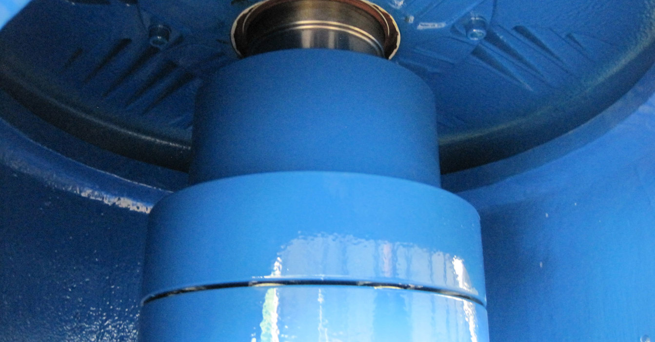 Close-up of a blue industrial component, possibly part of a pump system.