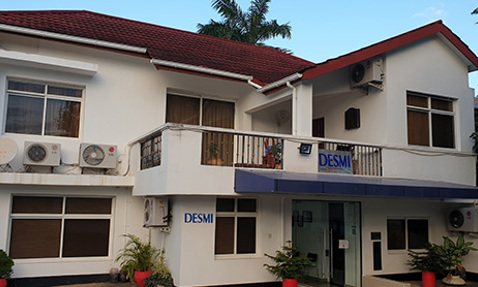 Two-story building with DESMI signage and multiple air conditioning units visible.