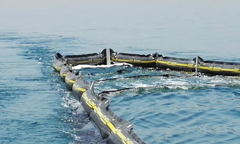 RO-BOOM containment barrier floating on water for oil spill response.