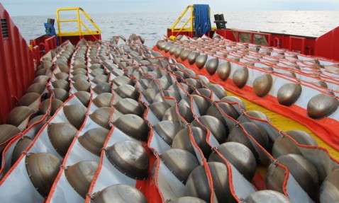 Rows of seismic nodes on a vessel deck, ready for deployment at sea.