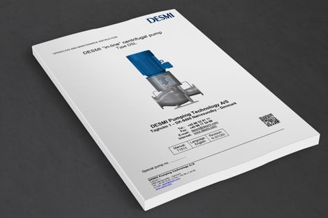 DESMI in-line centrifugal pump Type DSL manual på en mörk yta.