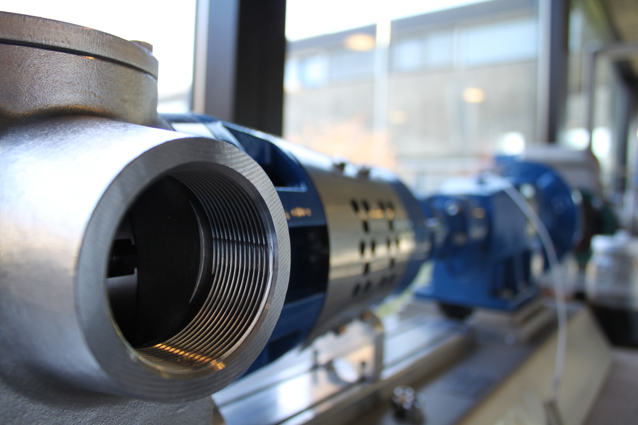 Close-up of a DESMI industrial pump for fluid handling in a workshop.